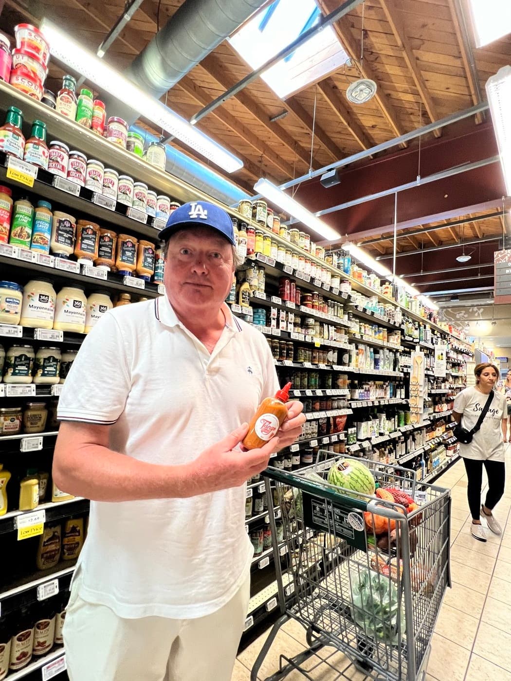 Customer holding Tango in the Whole Foods aisle